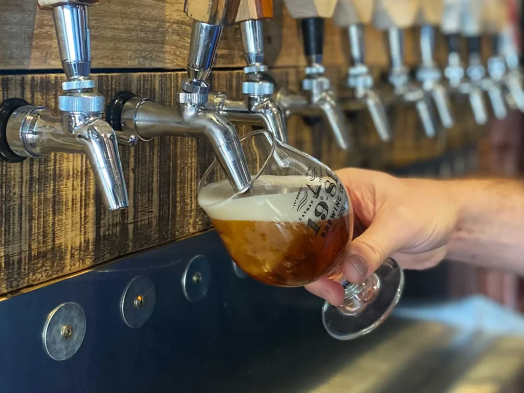 Cayman Islands Brewery fresh beer pouring from tap into glass.