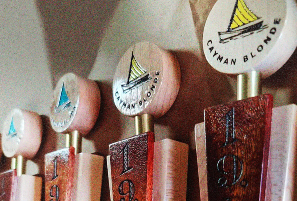 Close-up of our 19-81 Cayman beer taps, featuring Cayman Blonde, Tropical IPA, Island Session and Ridgefield Pils