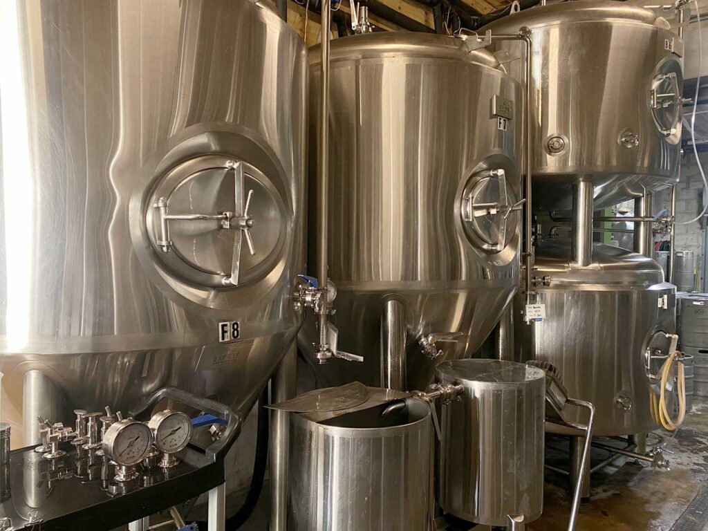 The interior of the 19-81 Brewing Co. building in Grand Cayman, featuring a sign with the brewery's logo