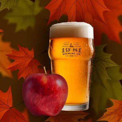 19-81 Brewing Co.'s Autumn Apple Ale with a red apple against fall leaves. Taproom exclusive.